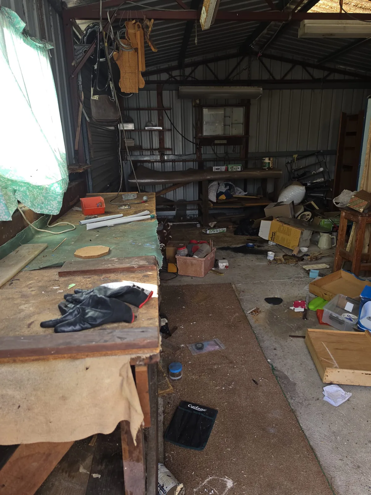 Cluttered workshop shed full of old tools and materials before a UZI Contracting clean-out in Perth