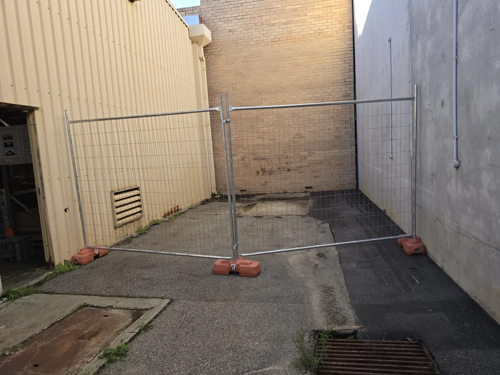 Temporary site fencing set up across a commercial laneway in Perth ready for works to start