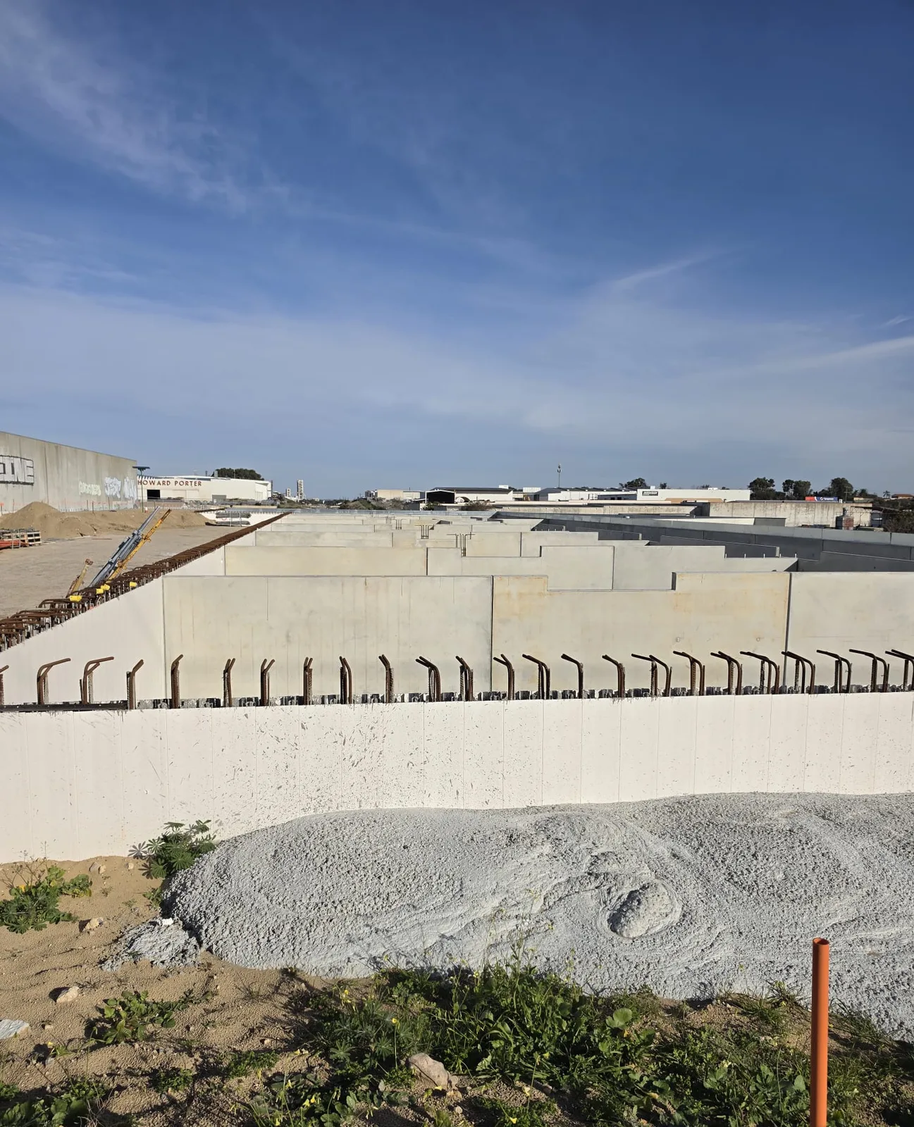 Concrete tilt-up panels and starter bars on a Perth industrial construction site where UZI supplied labour
